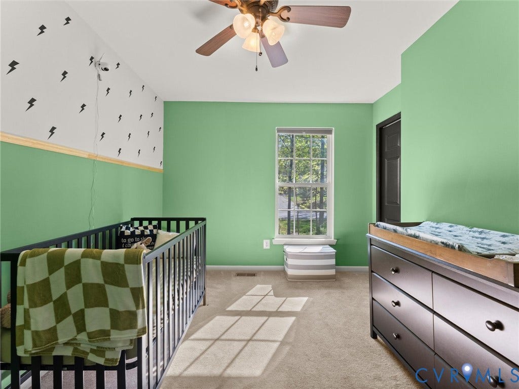 126 Reedy Creek Road, Reedy Creek, Louisa, VA 23093 The room features a window providing natural light, a ceiling fan, and carpeted flooring
