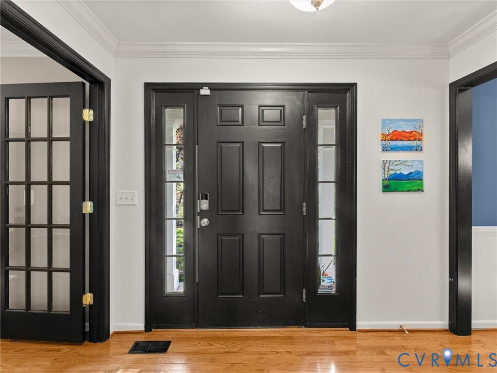 126 Reedy Creek Road, Reedy Creek, Louisa, VA 23093 Entryway featuring a black paneled door with sidelights, transom window, and hardwood floors