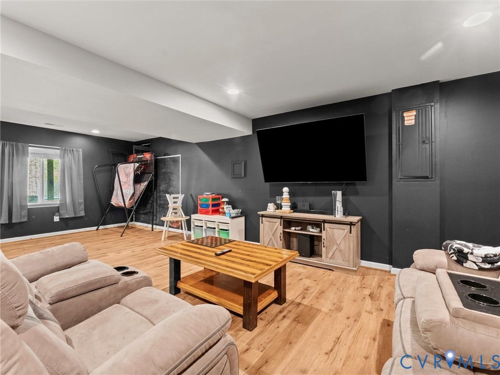 126 Reedy Creek Road, Reedy Creek, Louisa, VA 23093 This recreation room features wood-look flooring, a window providing natural light, and recessed lighting