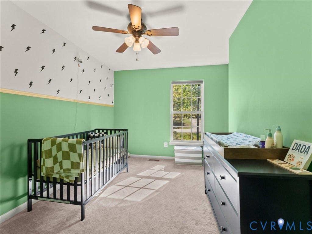 126 Reedy Creek Road, Reedy Creek, Louisa, VA 23093 This room features light green walls and carpeting, a window with natural light, and a ceiling fan