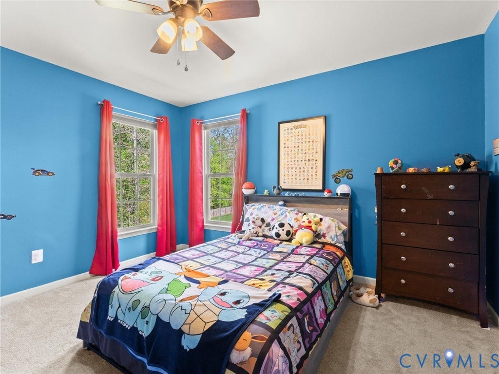 126 Reedy Creek Road, Reedy Creek, Louisa, VA 23093 This room features neutral carpeting, a ceiling fan, and two windows providing natural light