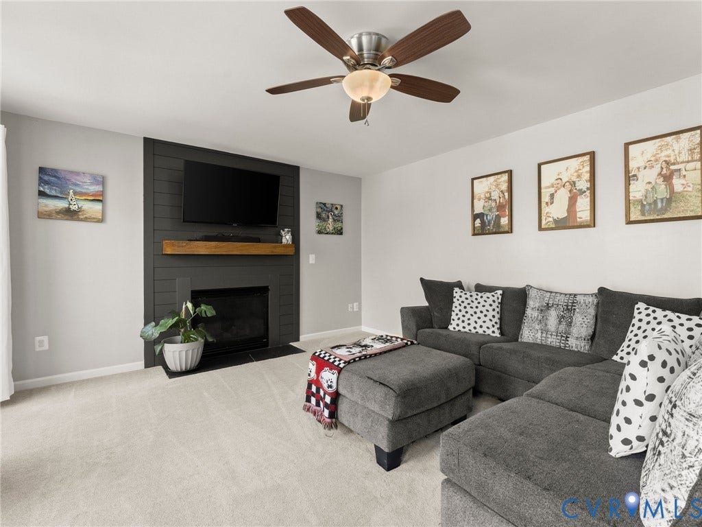 126 Reedy Creek Road, Reedy Creek, Louisa, VA 23093 The living room features a fireplace with a black shiplap surround and a wood mantel