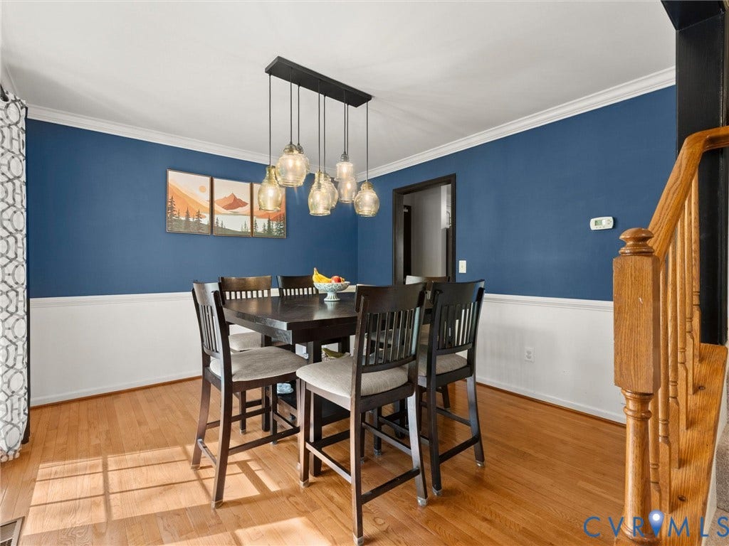126 Reedy Creek Road, Reedy Creek, Louisa, VA 23093 Dining area featuring hardwood floors, a two-tone wall with wainscoting and a deep blue accent, and a contemporary multi-light pendant fixture