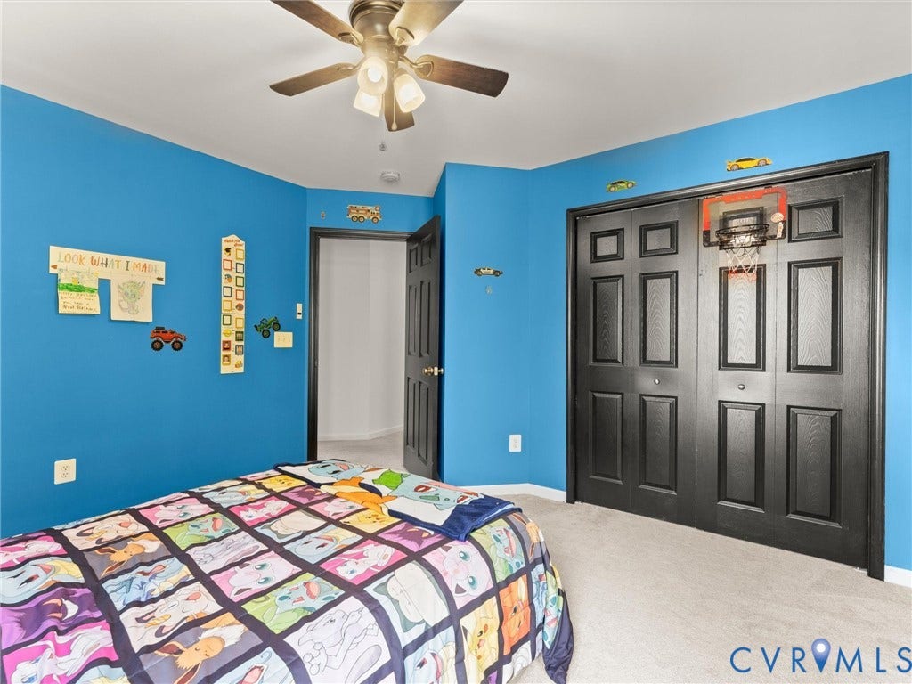 126 Reedy Creek Road, Reedy Creek, Louisa, VA 23093 This room features bright blue walls, light-colored carpeting, and a ceiling fan with light fixture