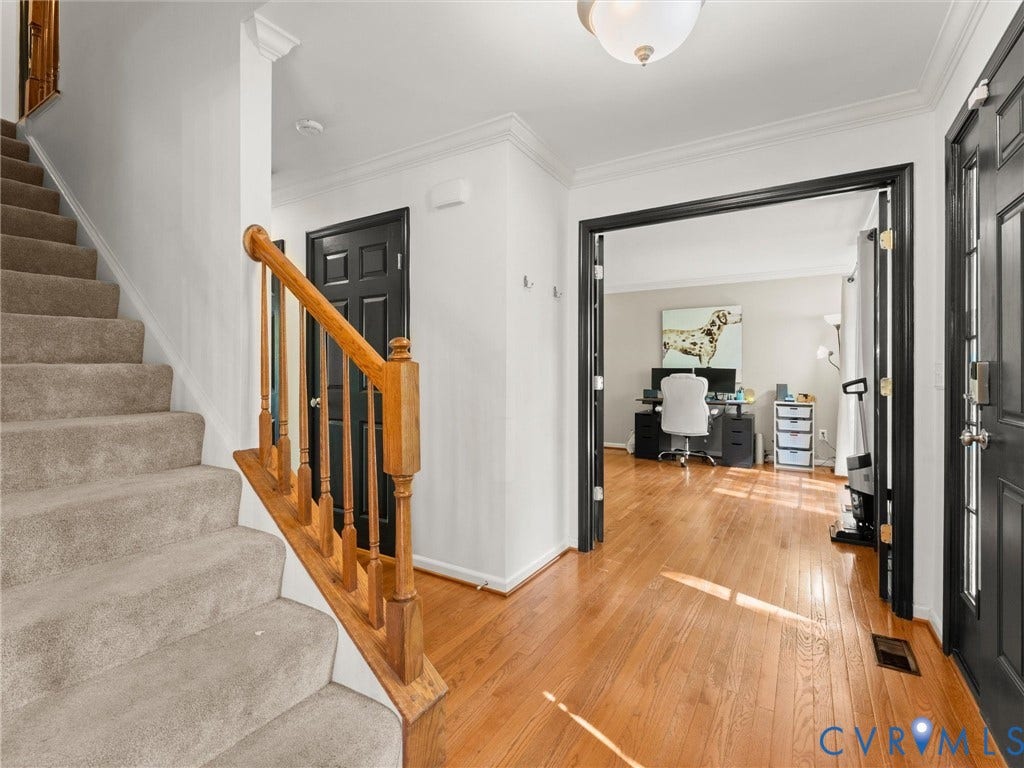 126 Reedy Creek Road, Reedy Creek, Louisa, VA 23093 The property features hardwood flooring in the entryway, a carpeted staircase with a wooden banister, and crown molding