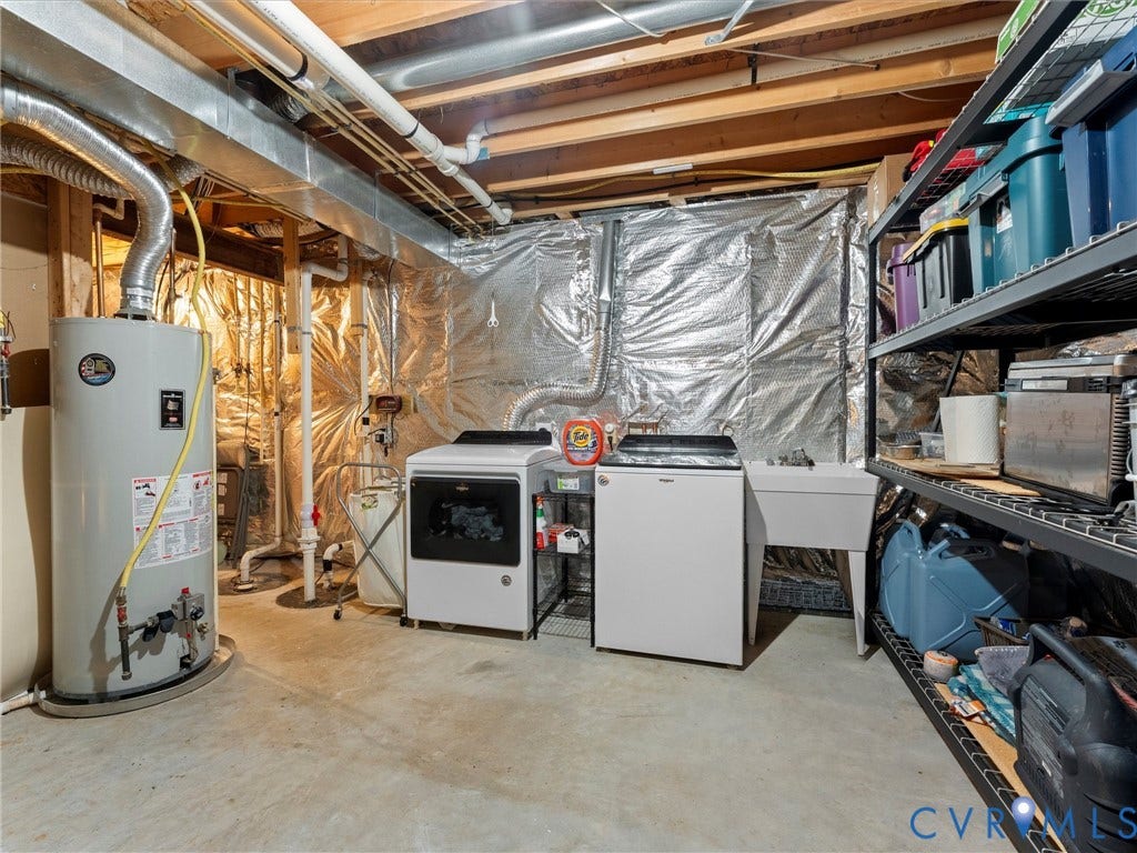 126 Reedy Creek Road, Reedy Creek, Louisa, VA 23093 The property features a utility area with a water heater, a washing machine, a dryer, and a utility sink