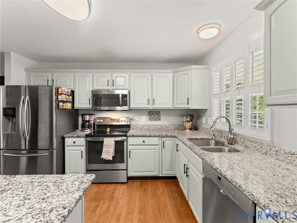 126 Reedy Creek Road, Reedy Creek, Louisa, VA 23093 The kitchen features light-colored cabinetry, stainless steel appliances including a refrigerator, oven, microwave, and dishwasher, and granite countertops