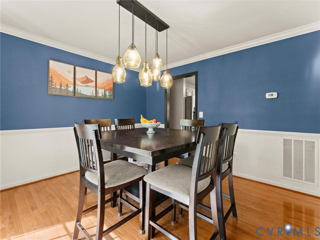 126 Reedy Creek Road, Reedy Creek, Louisa, VA 23093 This dining area features hardwood floors and a striking blue accent wall with white wainscoting