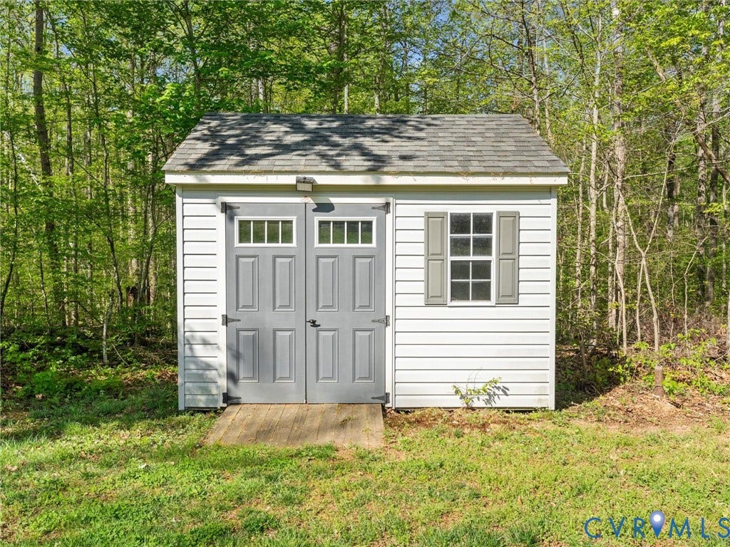 126 Reedy Creek Road, Reedy Creek, Louisa, VA 23093 This property features a shed with white siding, grey doors, and a window with grey shutters