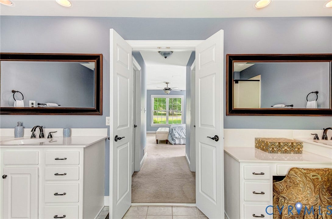 3131 Shadow Creek Drive, Powhatan, VA 23139 Bathroom featuring dual vanities with white cabinetry, dark hardware, and undermount sinks