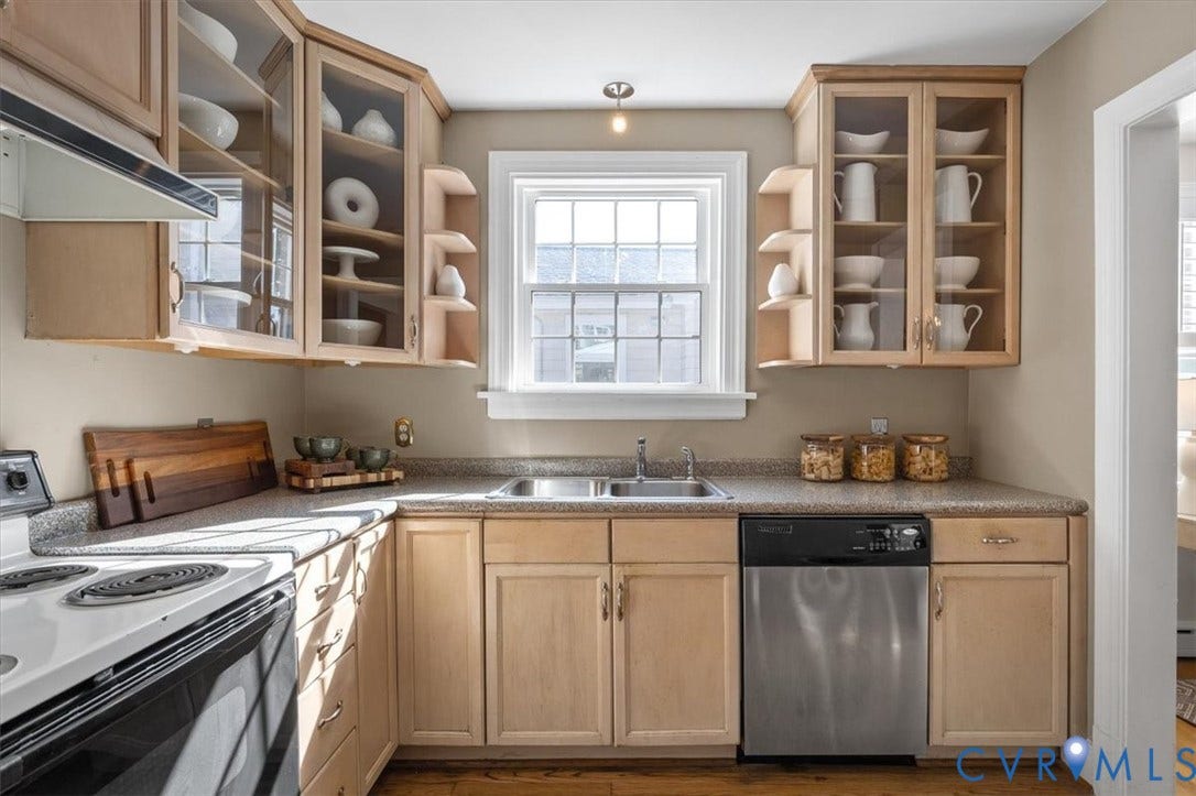 613 Maple Avenue, Near West End, Richmond, VA 23226 Galley kitchen featuring light wood-finish cabinetry, a double basin stainless steel sink, and a stainless steel dishwasher