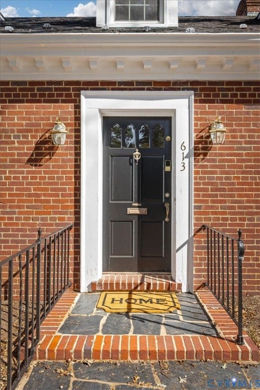 613 Maple Avenue, Near West End, Richmond, VA 23226 Brick exterior facade with a dark entry door featuring decorative glass panels