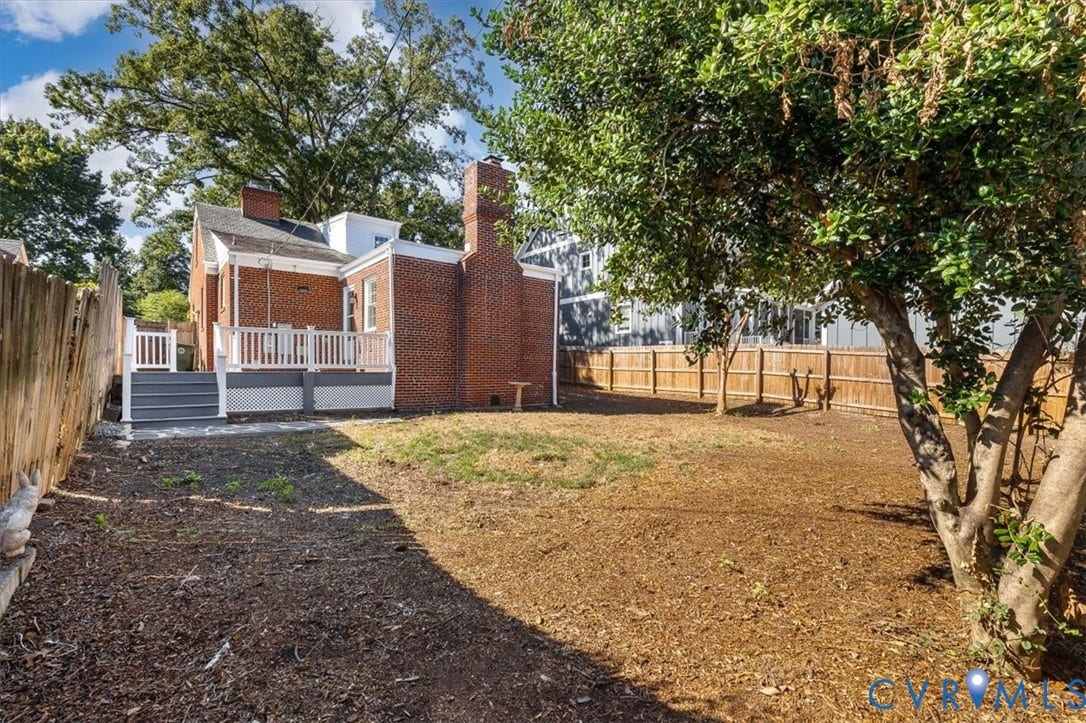 613 Maple Avenue, Near West End, Richmond, VA 23226 Expansive backyard featuring a brick exterior, multi-level composite deck, and partial wood fencing
