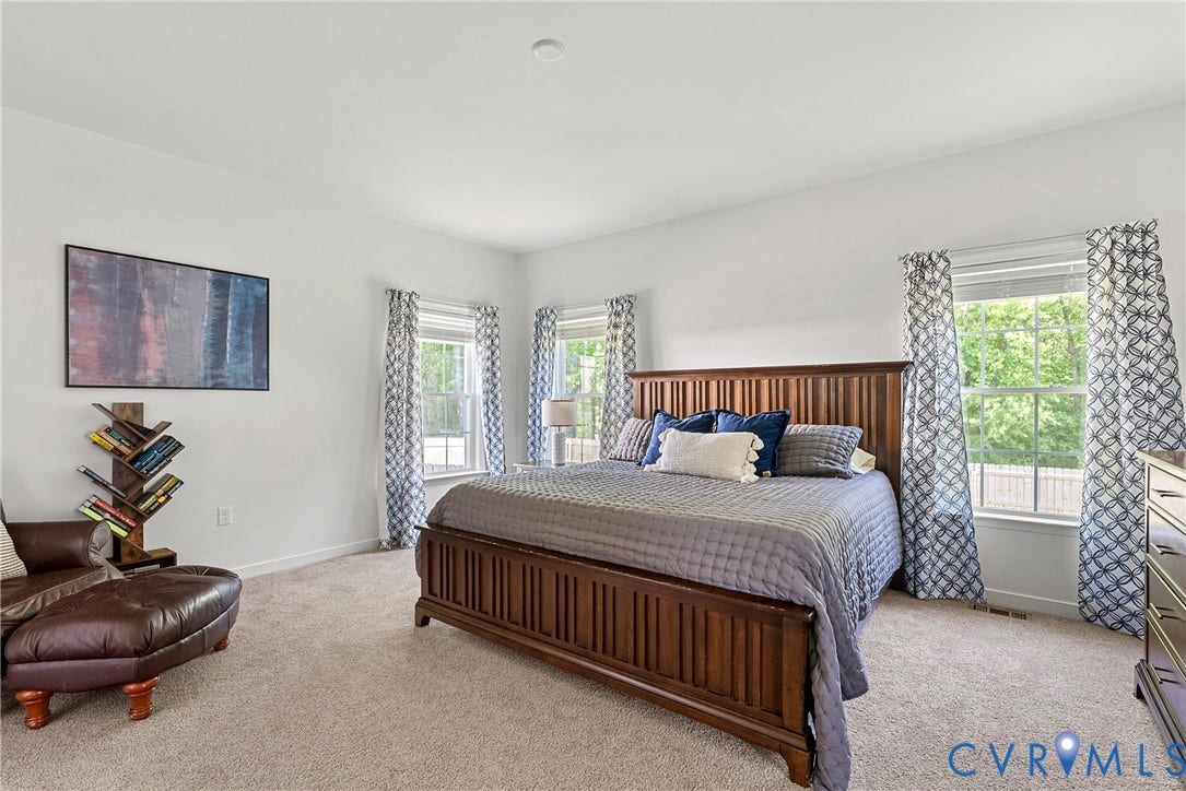 1605 Reed Marsh Place, Reed Marsh, Goodview, VA 23063 Spacious bedroom featuring neutral carpeting, abundant natural light from multiple windows, and crisp white walls
