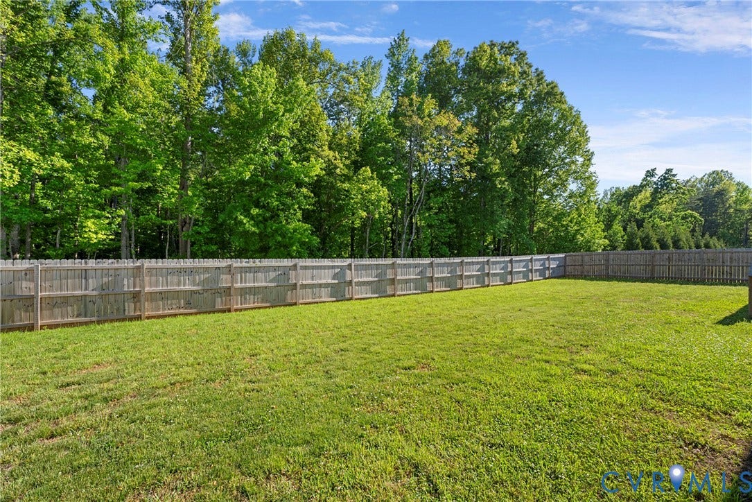 1605 Reed Marsh Place, Reed Marsh, Goodview, VA 23063 Expansive green lawn enclosed by a full privacy fence, backing up to private wooded lot.