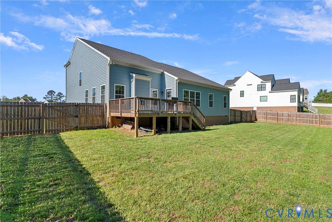 1605 Reed Marsh Place, Reed Marsh, Goodview, VA 23063 Expansive rear yard featuring a wooden privacy fence and a spacious wooden deck with stairs.
