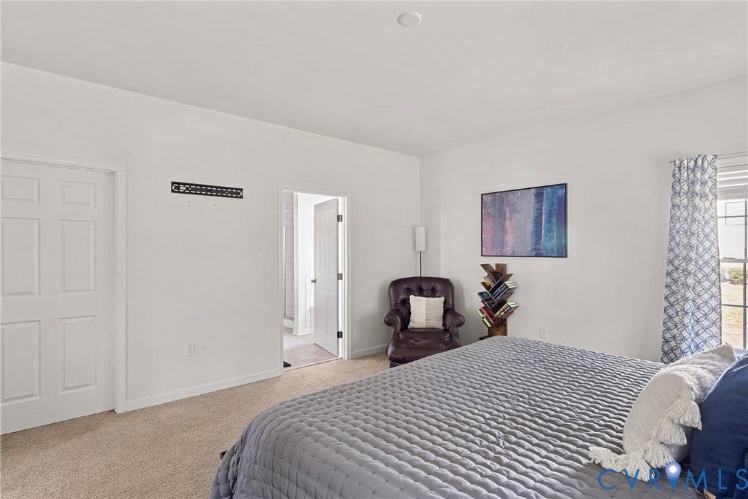1605 Reed Marsh Place, Reed Marsh, Goodview, VA 23063 Carpeted room featuring white walls, a window with patterned drapes, recessed lighting, and a paneled door