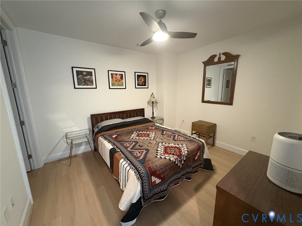 301 Virginia Street, #U804, Downtown, Richmond, VA 23219 Large Bedroom with en-suite bath, walk-in closet, hardwood floors and ceiling fan.