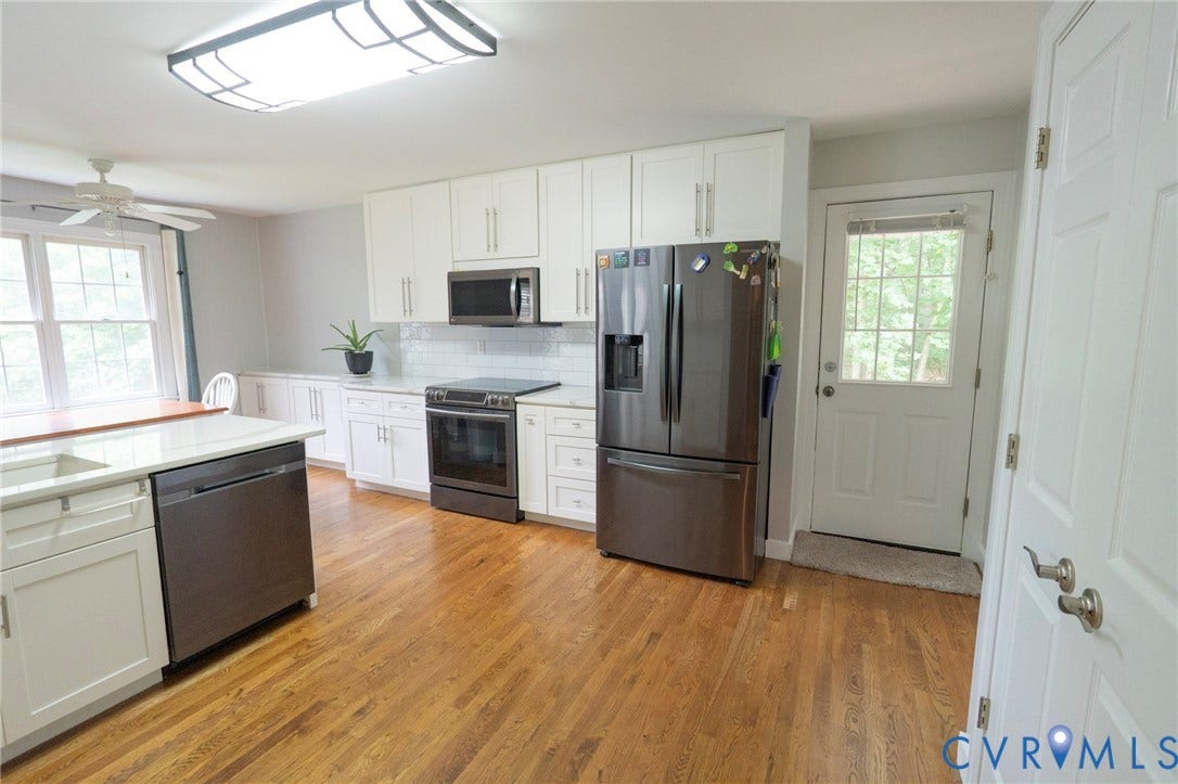 1670 Mill Quarter Road, Powhatan, VA 23139 Kitchen featuring white shaker cabinetry, stainless steel appliances, a white subway tile backsplash, and wood-finish flooring