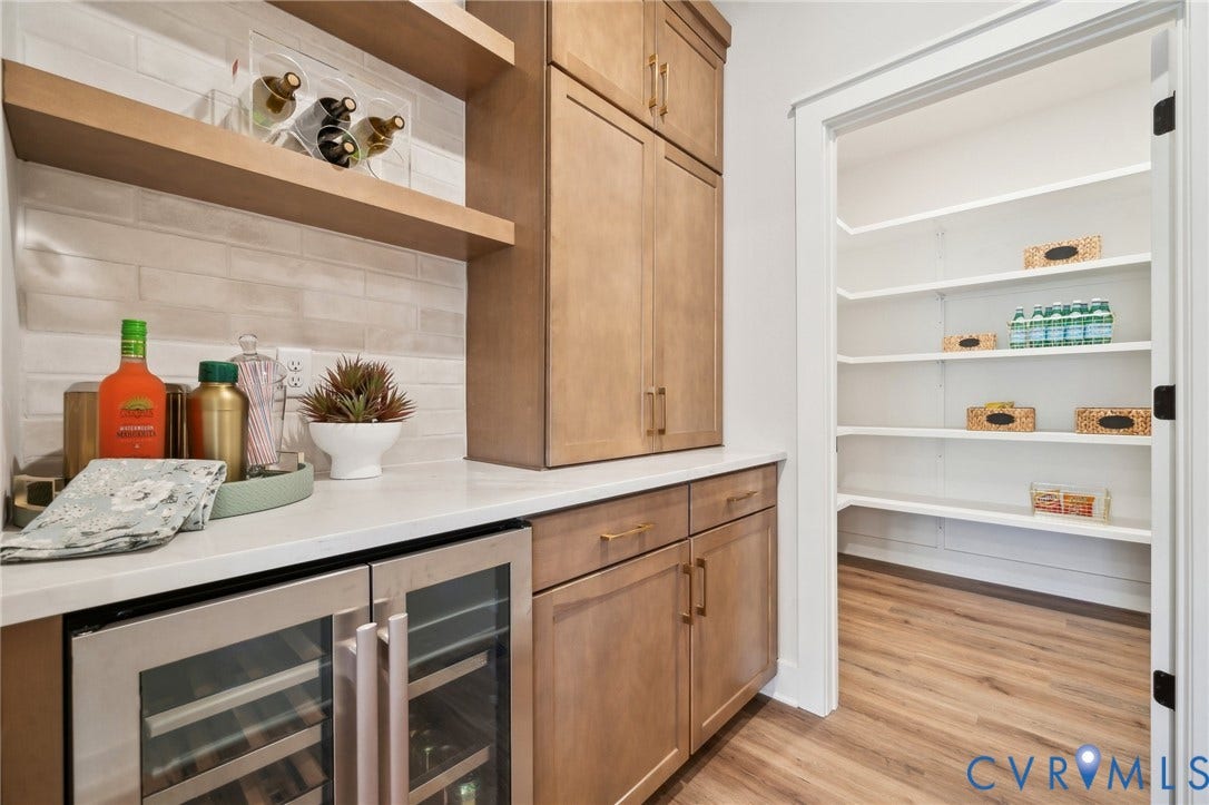 Upgraded butlers pantry, view to large walk-in pantry. Photo of model home.