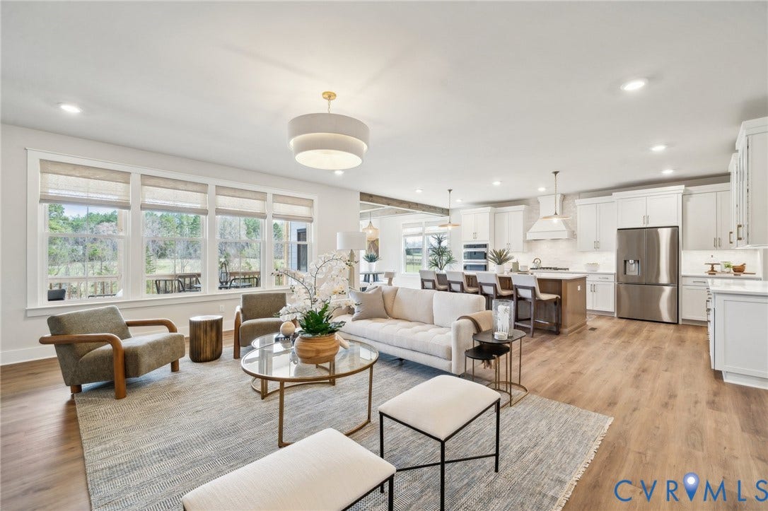View to kitchen and dinette. Photo of model home.