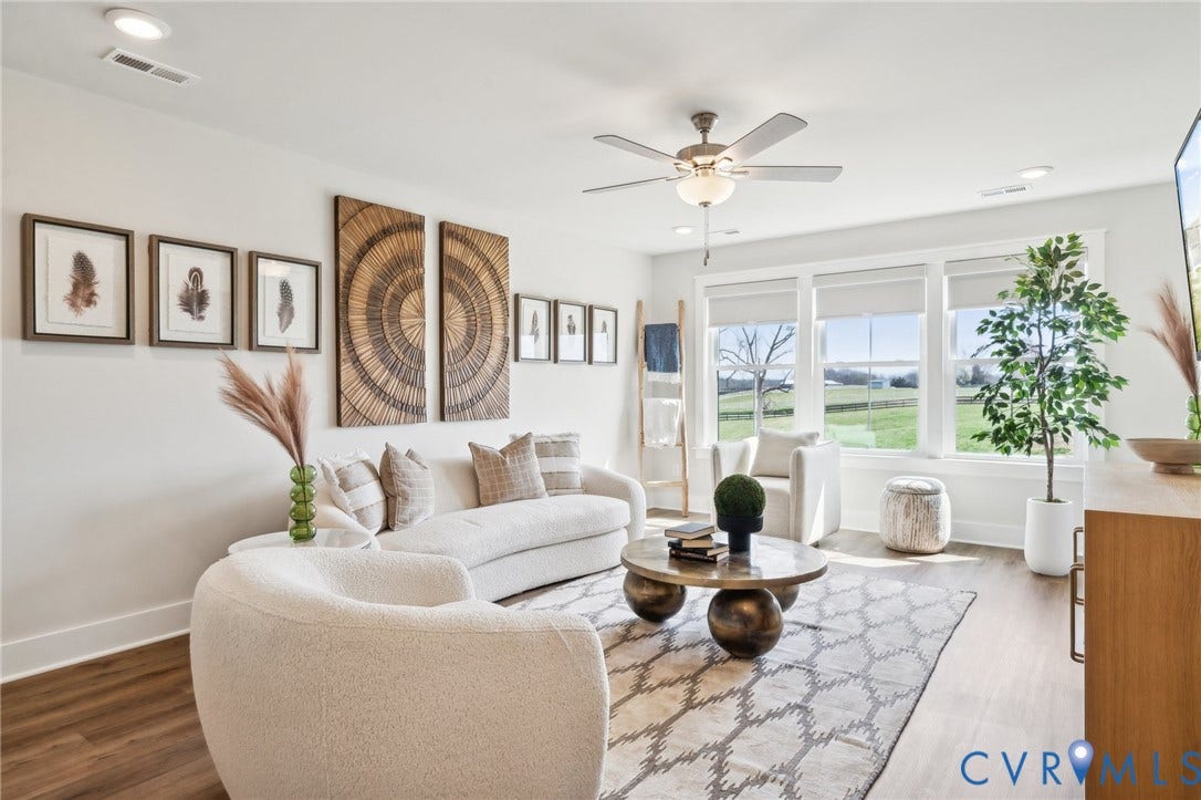 2nd floor living space. 2 beds and a full bath nearby. Photo of model home.