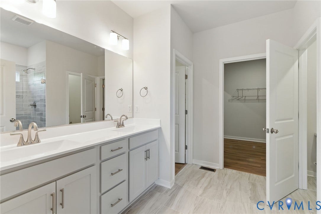 TBD Buckners (Lot 21) Lane, Compass Cove, Mineral, VA 23117 The primary ensuite bath includes dual vanities, a private water closet, and TWO walk-in closets