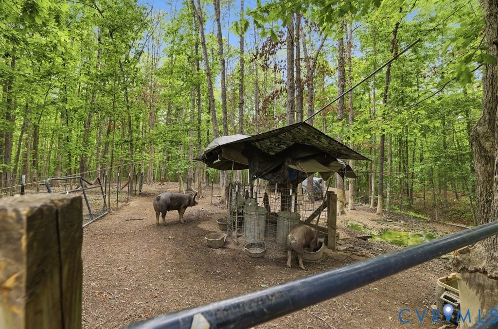 1061 Turkey Ridge Drive, Powhatan, VA 23120 Ready for your hobby farm, the property includes a fenced livestock area with a sheltered feeding station.