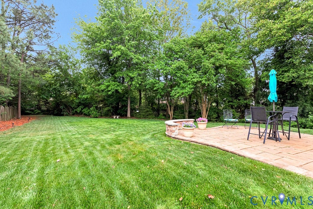 5841 Dorton Lane, Carrington, Glen Allen, VA 23060 There are flowering trees and bushes in the back yard.
