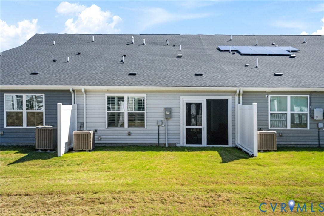 7236 George Wythe Lane, Summer Maple, New Kent, VA 23124 Rear exterior featuring a sliding glass door, white privacy screens, and a shingled roof