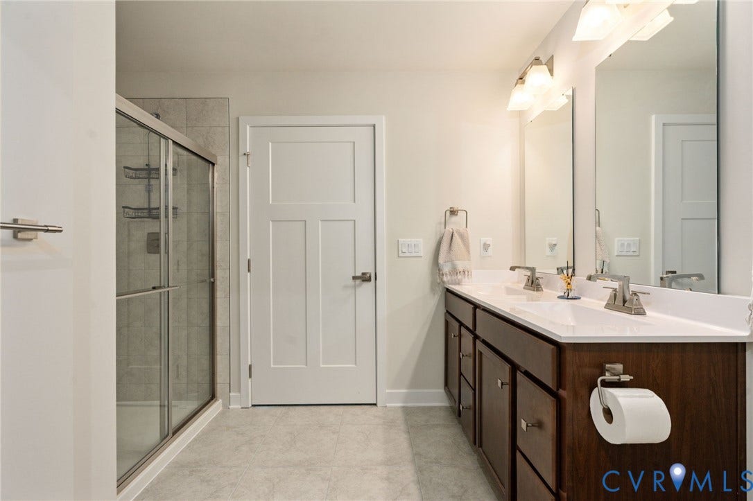 7236 George Wythe Lane, Summer Maple, New Kent, VA 23124 Bathroom featuring a dual vanity with white countertops, dark wood cabinetry, and brushed nickel fixtures