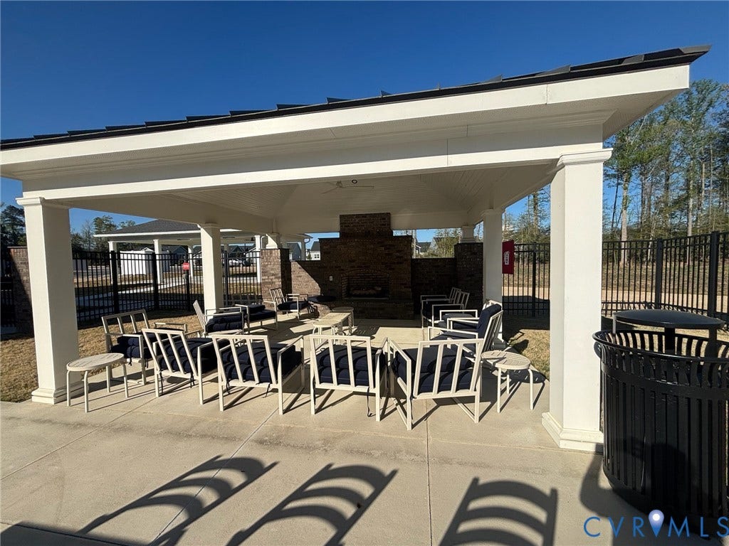 7236 George Wythe Lane, Summer Maple, New Kent, VA 23124 Expansive outdoor pavilion featuring a stone-clad fireplace and overhead lighting