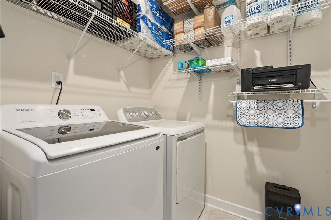 7236 George Wythe Lane, Summer Maple, New Kent, VA 23124 Dedicated laundry area featuring a top-load washing machine, front-load dryer, and extensive wire shelving for organization