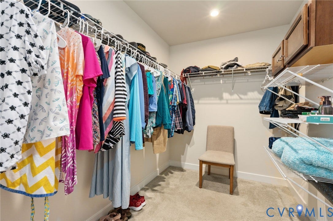 7236 George Wythe Lane, Summer Maple, New Kent, VA 23124 Spacious walk-in closet featuring extensive wire shelving, hanging rods, and an integrated overhead light fixture