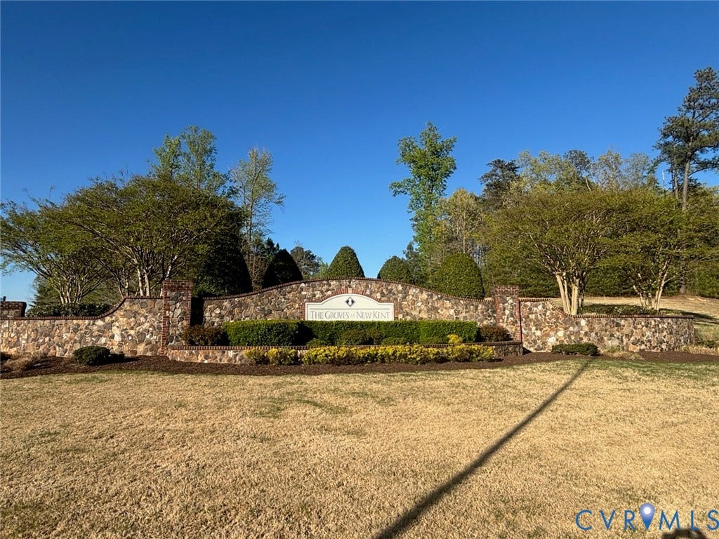 7236 George Wythe Lane, Summer Maple, New Kent, VA 23124 Stone and brick entrance wall featuring integrated signage and layered landscaping with mature trees