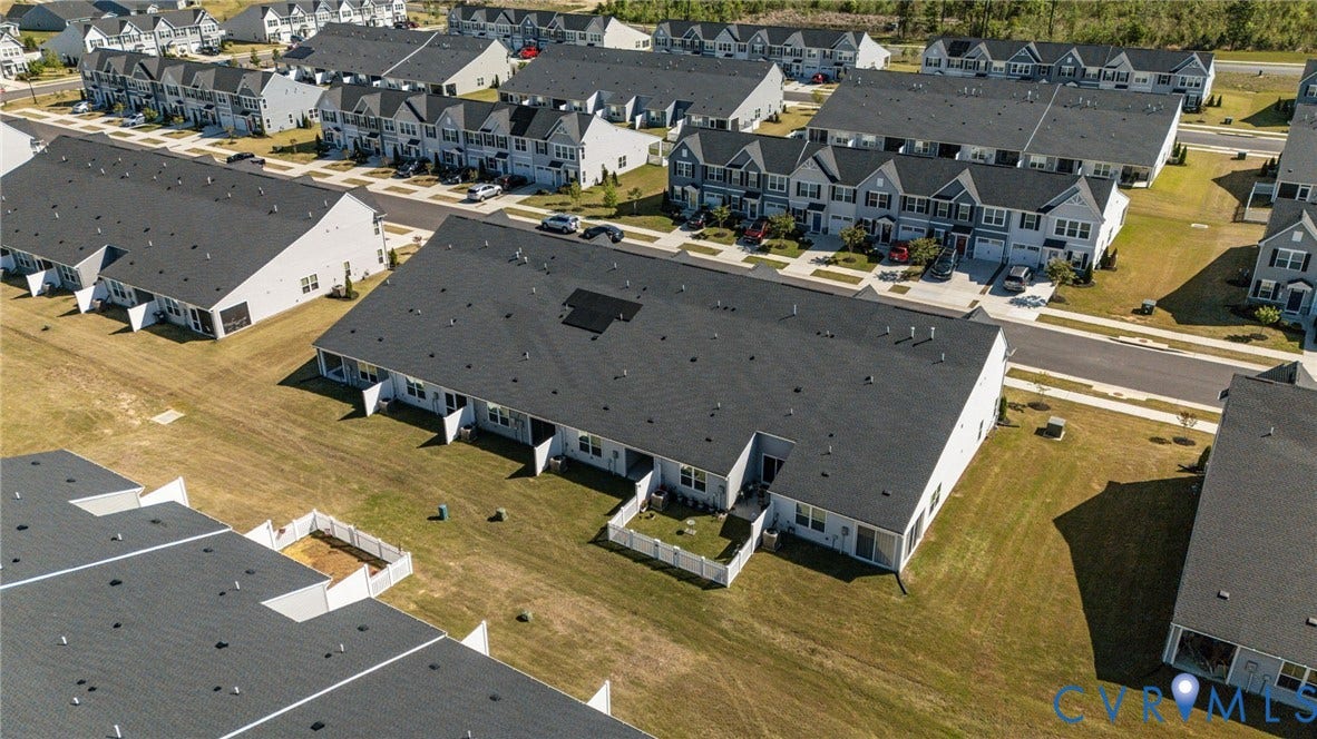 7236 George Wythe Lane, Summer Maple, New Kent, VA 23124 Aerial perspective of a multi-unit residential property, showcasing a dark shingle roof and a light-colored exterior