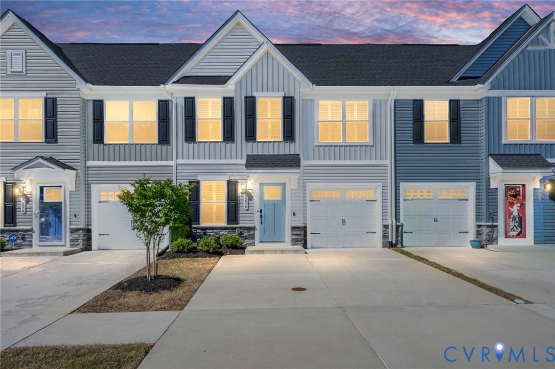7236 George Wythe Lane, Summer Maple, New Kent, VA 23124 Modern townhome exterior featuring light blue siding, black shutters, and an attached one-car garage with a panel door