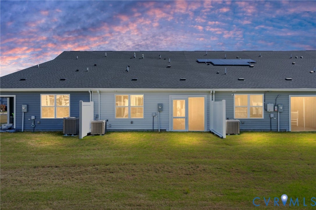 7236 George Wythe Lane, Summer Maple, New Kent, VA 23124 Rear exterior featuring horizontal siding in varied tones, multiple windows with interior blinds, and sliding glass doors