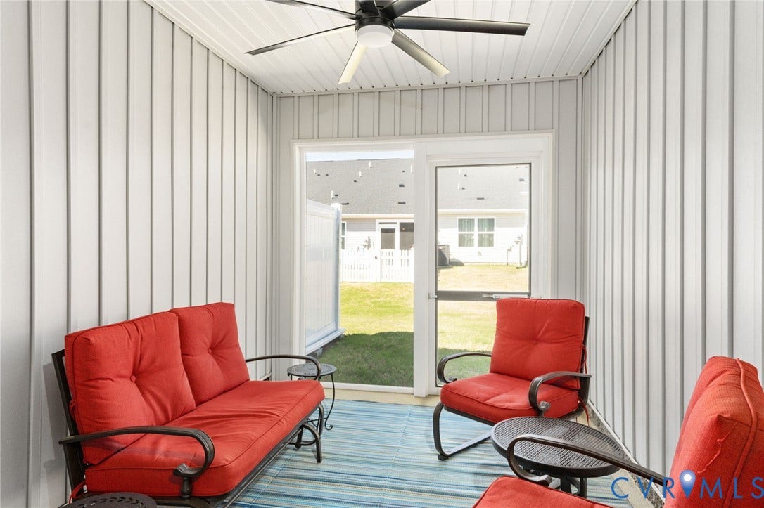7236 George Wythe Lane, Summer Maple, New Kent, VA 23124 Screened porch featuring vertical white paneling, ceiling fan with light fixture, and sliding glass door with screen
