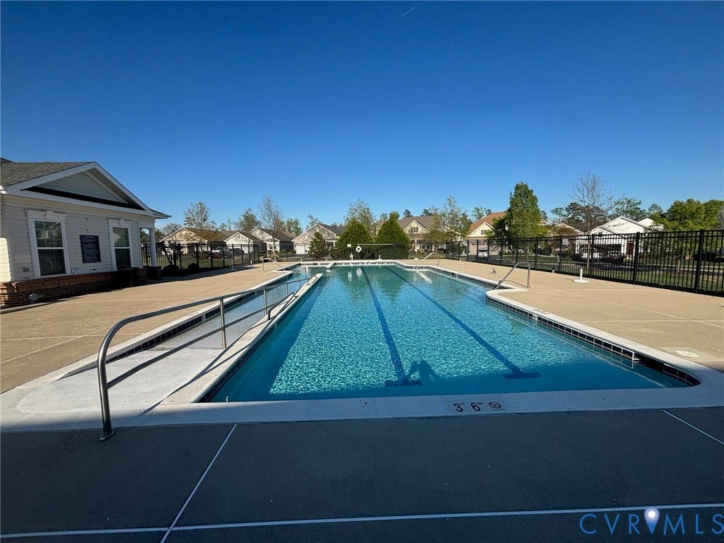 7236 George Wythe Lane, Summer Maple, New Kent, VA 23124 Expansive outdoor lap pool featuring clear water, lane lines, and a concrete deck