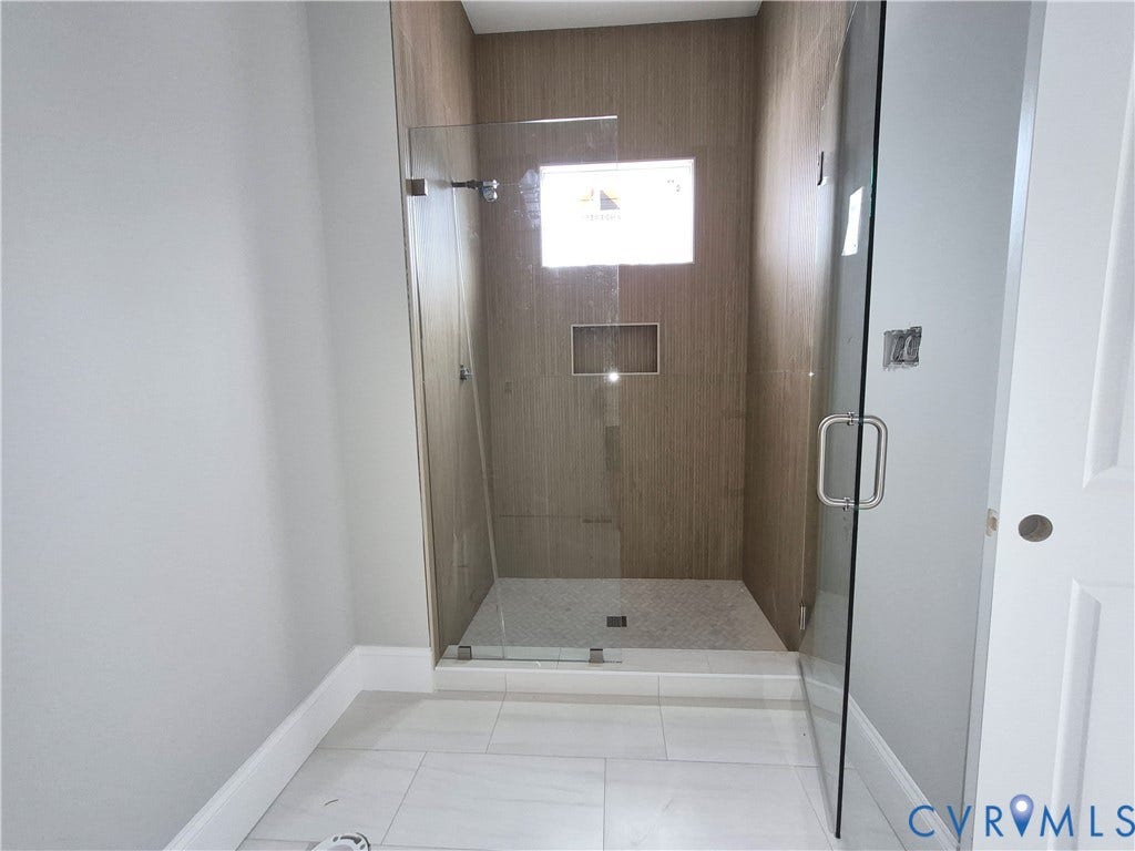 1554 Smokey Ridge Road, Breeze Hill, Maidens, VA 23102 Glass-enclosed shower with wood-look tile surround and mosaic floor