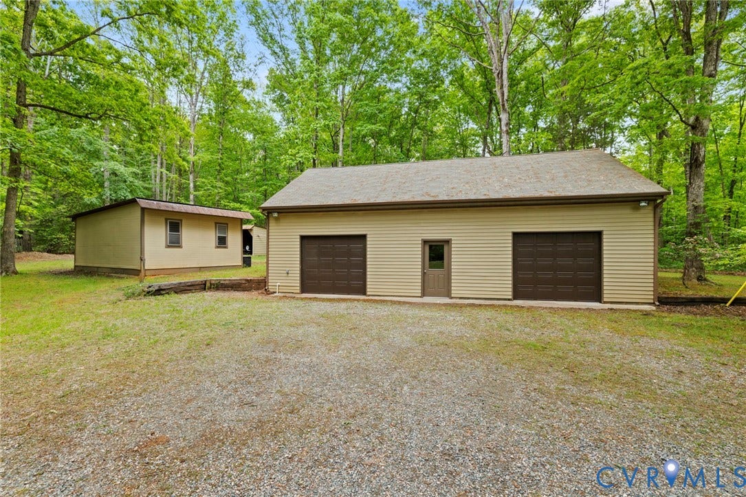 3172 Three Bridge Road, Powhatan, Powhatan, VA 23139 Detached garage with finished space on 2nd floor, new garage doors (2025), and newer windows (2011).