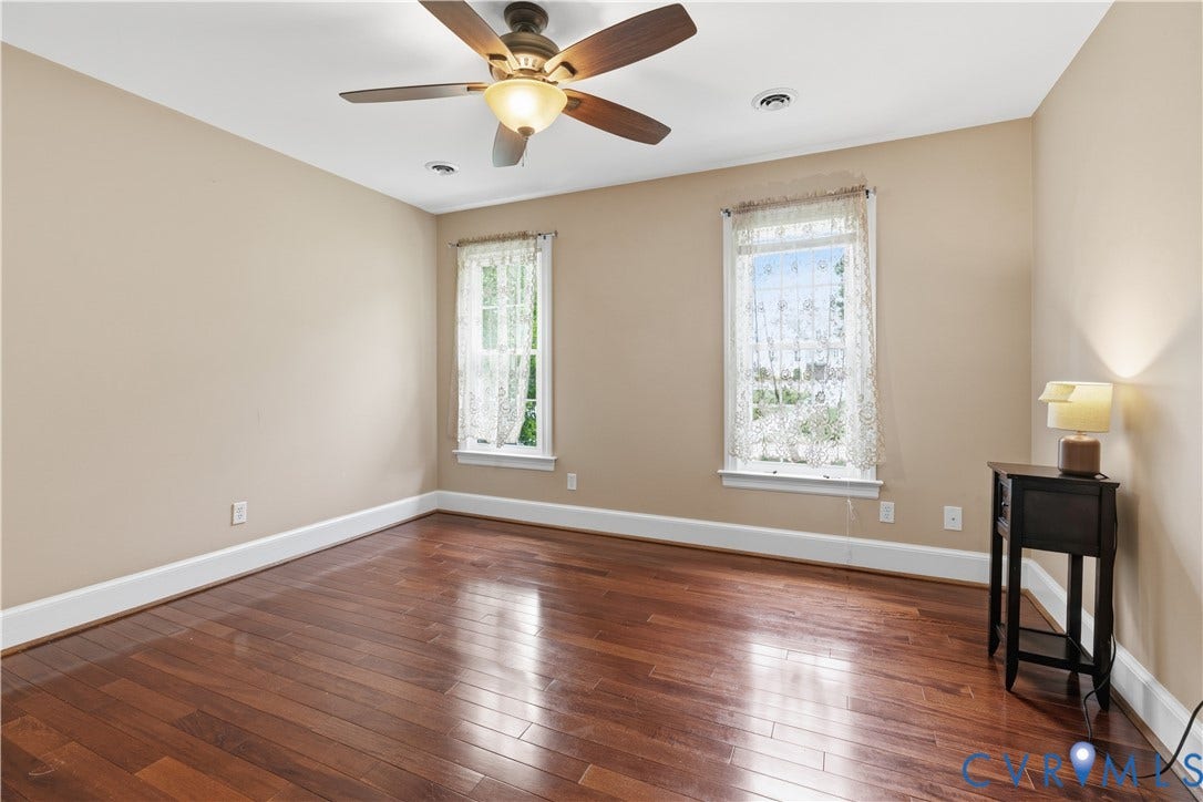 9803 Gates Bluff Drive, Gates Bluff, Chesterfield, VA 23832 Room featuring rich wood-finish flooring, two large windows, a ceiling fan with integrated lighting, recessed lighting, and neutral wall tones