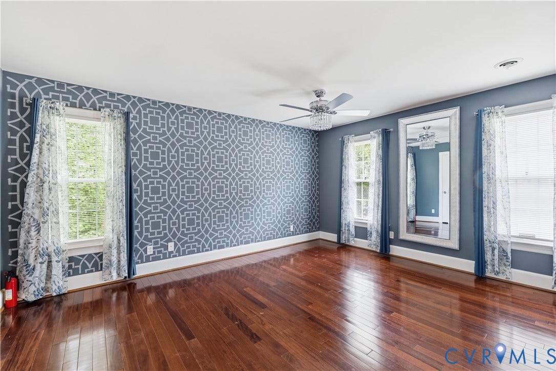 9803 Gates Bluff Drive, Gates Bluff, Chesterfield, VA 23832 Hardwood flooring throughout the room, featuring a patterned accent wall