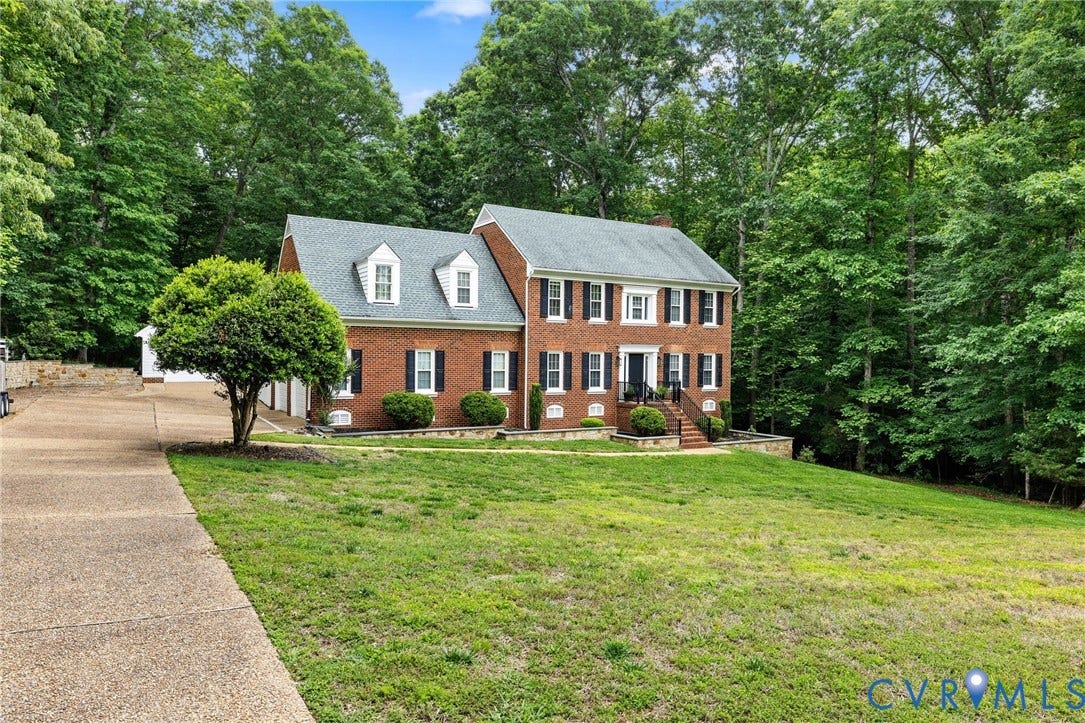 9803 Gates Bluff Drive, Gates Bluff, Chesterfield, VA 23832 Two-story brick exterior featuring a multi-car driveway, mature landscaping, and a broad front lawn