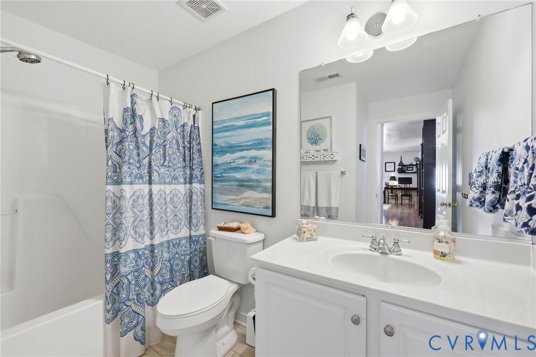 4909 Parsons Walk Place, Twin Hickory, Glen Allen, VA 23059 Bathroom featuring a white vanity with a single basin sink, an expansive wall mirror, and a classic white toilet