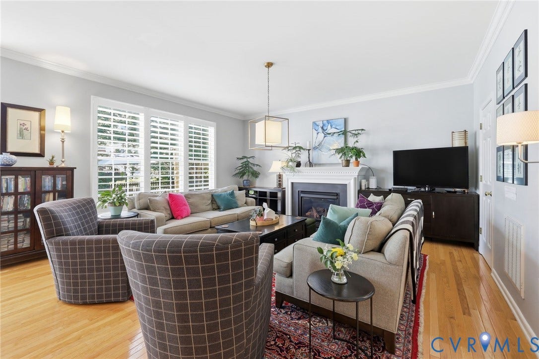 4909 Parsons Walk Place, Twin Hickory, Glen Allen, VA 23059 Living area featuring hardwood flooring, triple window with plantation shutters, crown molding, and a fireplace with a white mantel