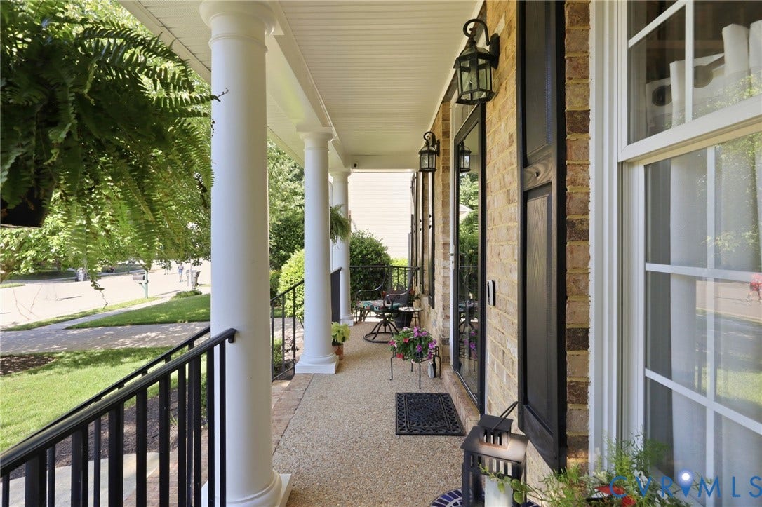 4909 Parsons Walk Place, Twin Hickory, Glen Allen, VA 23059 Front porch featuring brick veneer siding, multiple white columns, a textured aggregate surface, and a black metal railing system