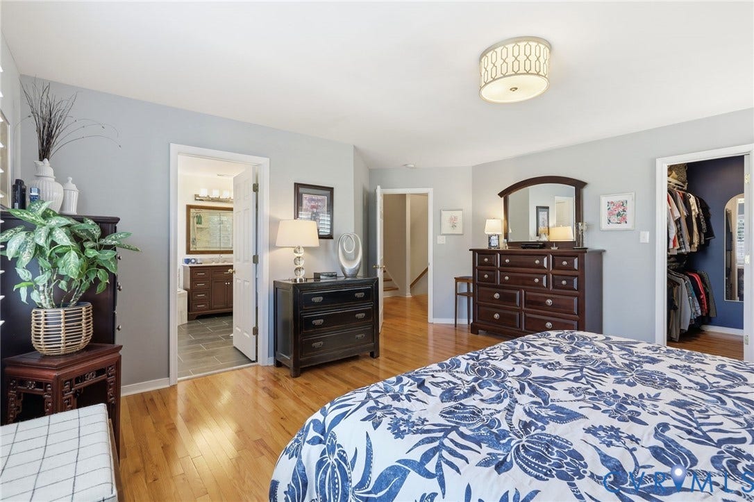 4909 Parsons Walk Place, Twin Hickory, Glen Allen, VA 23059 Hardwood flooring and light gray walls define this spacious room, featuring a modern flush-mount ceiling light