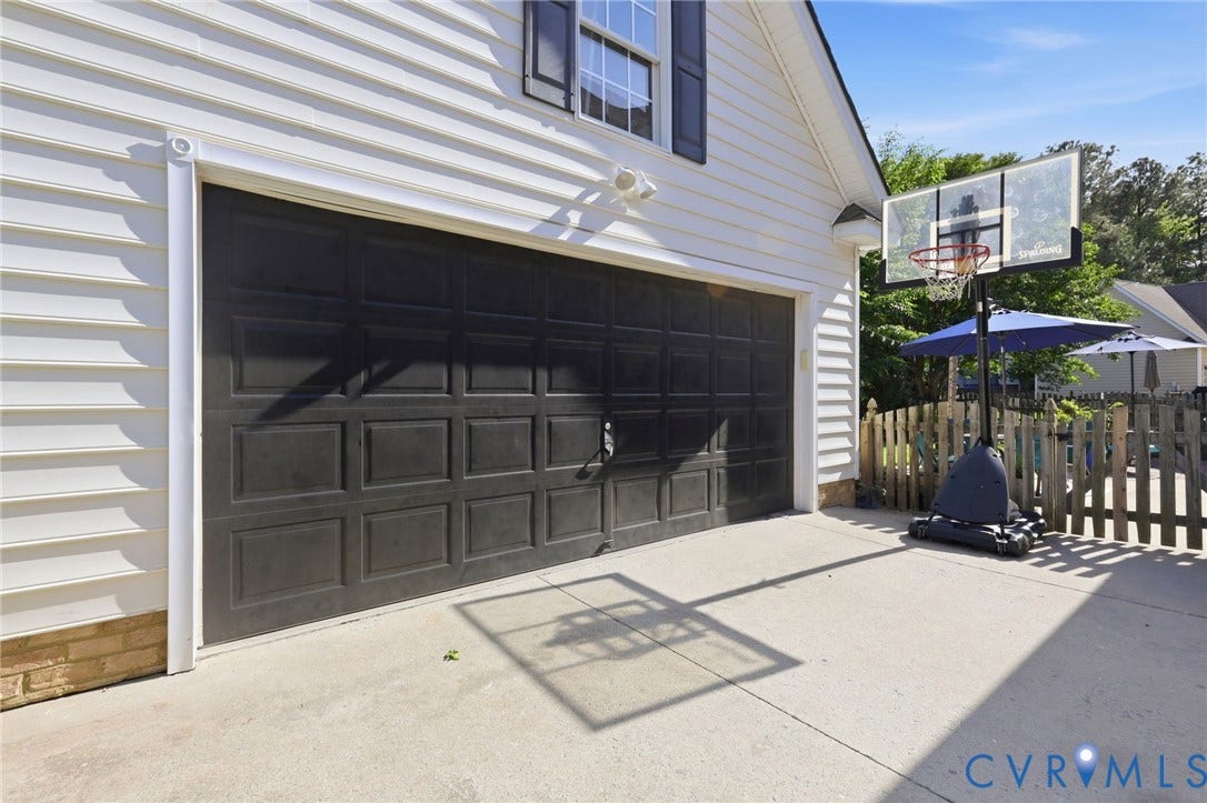 4909 Parsons Walk Place, Twin Hickory, Glen Allen, VA 23059 Two-car garage with paneled door and white siding
